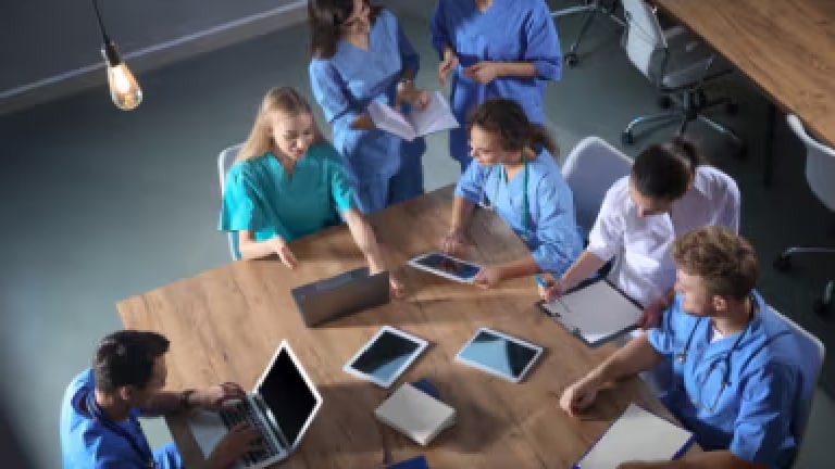 Healthcare professionals looking at disease education information